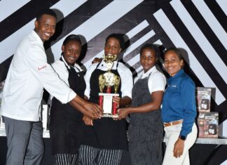 (From left) Executive chef at Sandals Negril, Delroy Haye hands over the coveted trophy to the members of the winning team, Monique Thomas, Iona Robinson and Dannese Jones; also present for the hand over was Sandals Negril hotel manager, Melissa Clarke.