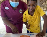 Kids Camp Counsellor at Beaches Negril, Pollyanna Wallace assisted Amari Malcom from Broughton Primary School in painting the starfish he saw at sea on his glass bottom boat tour with the Sandals Negril and Beaches Negril team.