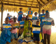 Beaches Negril playmaker, Shyanne Miller (center) took on the job as mermaid for World Oceans Day and was pleased to strike a pose with grade 4 students from Broughton Primary School, as they proudly showed off their paintings.