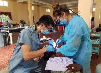 Great Shape! Inc. volunteer dental hygienists conducts a dental procedure at a 1000 Smiles Dental Clinic in 2019.