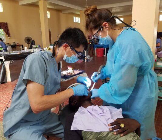 Great Shape! Inc. volunteer dental hygienists conducts a dental procedure at a 1000 Smiles Dental Clinic in 2019.
