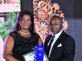 Monique Munroe (left), Sandals Negril’s reigning Diamond Team Member of the Year accepts her award from resort General Manager, David Latchimy.