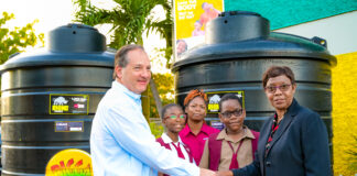 Wisynco’s Director of Marketing, Francois Chalifour (left) and Half Way Tree Primary School Principal Carol O’Connor Clarke (right), shake hands during the presentation of two 1,000 gallon water storage tanks to the institution on Thursday, January 19. The request from the institution’s Parent Teacher Association (PTA) was granted as part of Wisynco’s Bigga Soft Drink brand’s drive to support proper sanitation in schools which have a challenge with access to consistent running water. Looking on are Half Way Tree Primary School’s PTA 2nd VP, Tresha Hamilton Dunkley (centre); Head Girl, Erica Bernard (2nd from left) and Deputy Head Boy, Adjae McHugh (2nd from right).