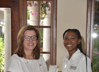 Air Canada, Senior Manager Regional Sales Global Sales Air Canada group, Edna Ray, handing over a donation of items for teen moms to Sandals Regional Public Relations Coordinator for Montego Bay Ashley Simms, who accepts on behalf of the Sandals Foundation.