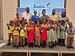 General Manager at Sandals South Coast, O’Brian Heron (second left) was pleased to share in the moment with the Inter-School Literacy competitors and teachers.