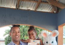 General Manager of Sandals Montego Bay Christopher Elliott happily poses for a picture with the Easter bunny and four-year-old Deneisha McFarlane of Whitehouse.