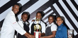 (From left) Executive chef at Sandals Negril, Delroy Haye hands over the coveted trophy to the members of the winning team, Monique Thomas, Iona Robinson and Dannese Jones; also present for the hand over was Sandals Negril hotel manager, Melissa Clarke.