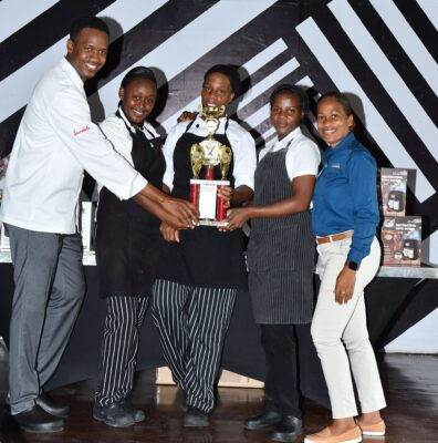  (From left) Executive chef at Sandals Negril, Delroy Haye hands over the coveted trophy to the members of the winning team,  Monique Thomas, Iona Robinson and Dannese Jones; also present for the hand over was Sandals Negril hotel manager, Melissa Clarke.