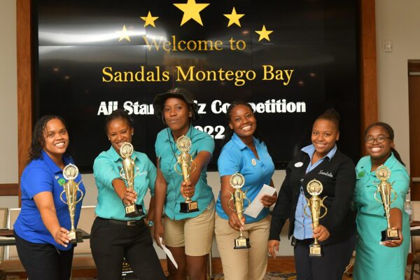 The Phoenix team, champions of the Sandals Montego Bay  All Stars Quiz Competition show off the hardware. From (left to right) are: Veronica Campbell, Althea Walker-Mighty, Daniella Sterling, Shantoy Blaygrove, Amanda Mitchell and Shannakay Spence.