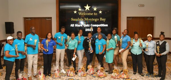 Members of the winning and second place teams in the Sandals Montego Bay All Star Quiz Competition proudly pose with their trophies and prizes received from General Manager Christopher Elliott (sixth from right) following the grand finals at the resort on Tuesday.