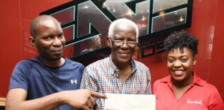 Sharing smiles at the prize handover for the Sandals Resorts International and EDGE FM Soulful Dad competition are (l-r) Dwight Hewitt, son of Trevor Hewitt, Trevor Hewitt, winner of the competition and Jennese Palmer, Public Relations Manager at SRI. Hewitt has won for himself an all-inclusive luxury weekend for 4 at any local Beaches Resort in honour of being an amazing father.