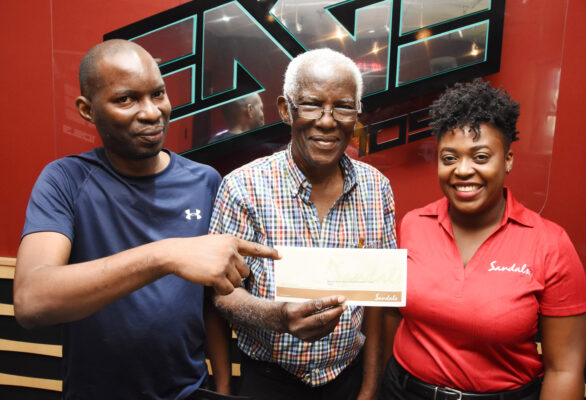 Sharing smiles at the prize handover for the Sandals Resorts International and EDGE FM Soulful Dad competition are (l-r) Dwight Hewitt, son of Trevor Hewitt, Trevor Hewitt, winner of the competition and Jennese Palmer, Public Relations Manager at SRI. Hewitt has won for himself an all-inclusive luxury weekend for 4 at any local Beaches Resort in honour of being an amazing father.