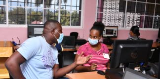 A Great Shape! Inc. volunteer interacts with a local teacher during a training session.