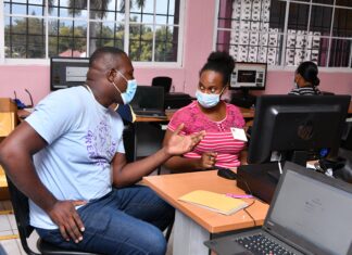 A Great Shape! Inc. volunteer interacts with a local teacher during a training session.