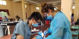 Great Shape! Inc. volunteer dental hygienists conducts a dental procedure at a 1000 Smiles Dental Clinic in 2019.