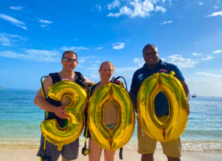 (From left) Diving couple Norman and Tracy Krobath proudly celebrates their diving milestones with Sandals Negril’s scuba instructor Sangha Spencer who led their excursions.