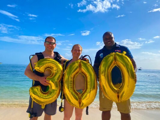 (From left) Diving couple Norman and Tracy Krobath proudly celebrates their diving milestones with Sandals Negril’s scuba instructor Sangha Spencer who led their excursions. 