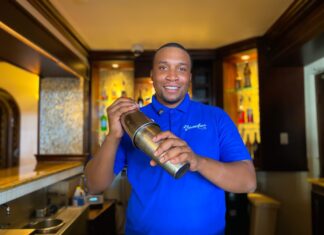 Beach Negril Bar Supervisor, Nekoro Vassell shares a warm smile as he creates his signature drink.