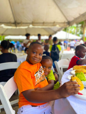 (From left) Damarion Smith and Josiah Case grabbing a quick bite before taking on all the exciting activities at the Beaches Negril family fun day.