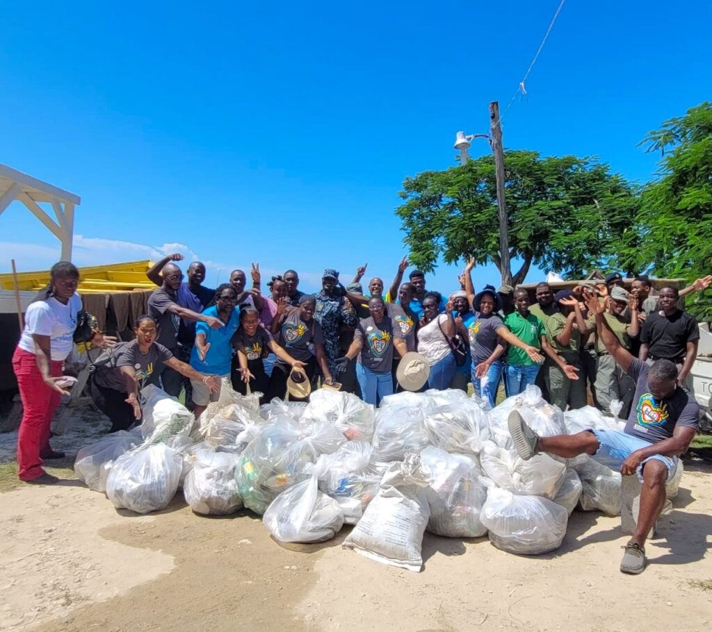 The team pauses for a quick photo with the over 40 bags of garbage which they collected on International Coastal Cleanup Day.