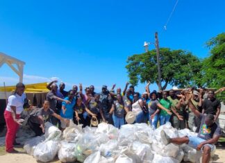 The team pauses for a quick photo with the over 40 bags of garbage which they collected on International Coastal Cleanup Day.