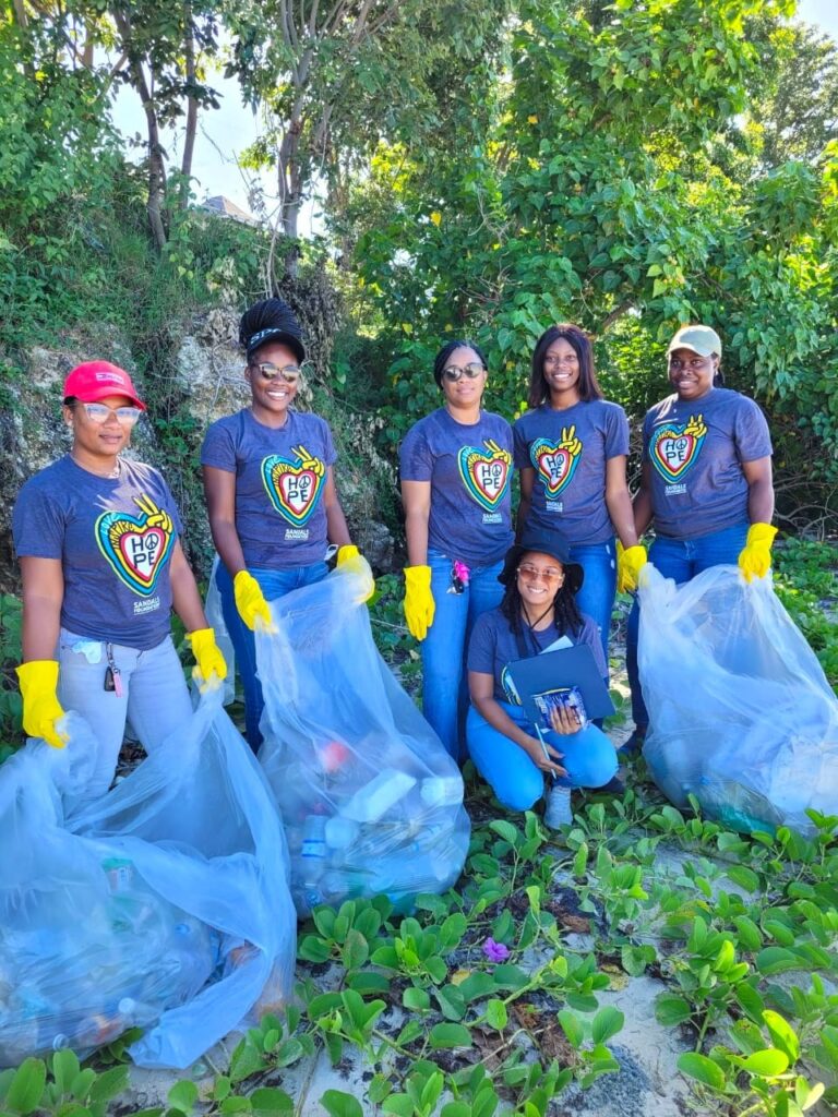 Sandals South Coast Club Sandals Manager, Tracey Gray (3rd left) and Butler Manager, Donna Daniel (kneeling) are joined by their team members (l-r) Chloe-Ann Davis, Jhanelle James, Jobian Foster and Laura Smith for an International Coastal Cleanup activity at the Whitehouse Fishing Beach over the weekend. Here the team paused from their efforts to show us some of what they collected.