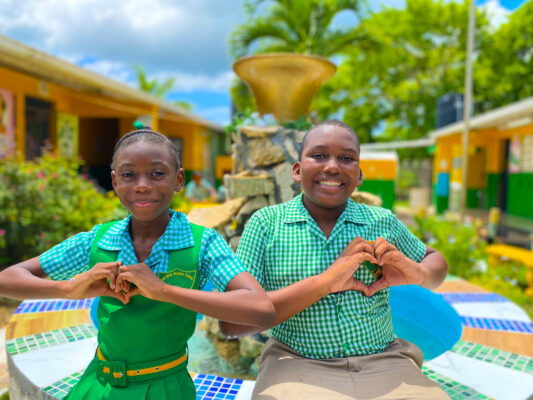 Grade 5 students and the Pell River Primary School Dejanae Pearce and Jaheim Jerry smiled as they sat in their recently renovated peace garden done by the Sandals Foundation.