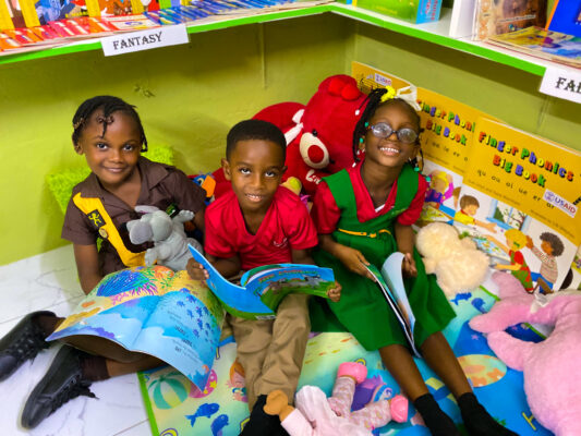 Pell River students (from left) Kacia Earle, Liam Owens and Kylie Jones sat down for a quiet and cozy reading session in their newly renovated library courtesy of the Sandals Foundation.