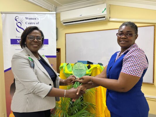 Director of Field Operations at the Women’s Centre Beverly Martin- Berry (RIGHT) presentation a plaque of appreciation to Dawn Smith. General Manager of Sandals Royal Caribbean who accepts on behalf of the Sandals foundation.