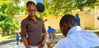 Shane Smyle, a Physiotherapist from the Board of Supervision in the Ministry of Local Government and Community Development checks the blood pressure of a homeless man on World Homeless Day at the Drop-in Centre in Black River.