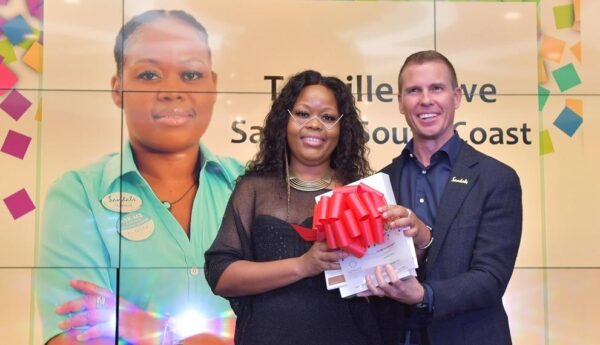 Tennille accepts her awards from Sandals Resorts International Executive Chairman, Adam Stewart.