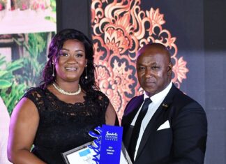 Monique Munroe (left), Sandals Negril’s reigning Diamond Team Member of the Year accepts her award from resort General Manager, David Latchimy.