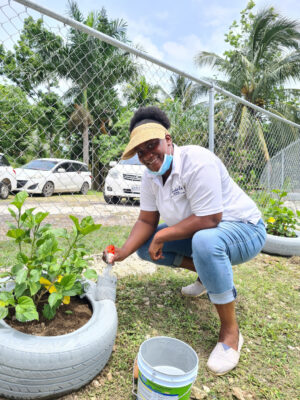 Always out volunteering, Monique Munroe is captured getting a peace garden donated by Sandals and Beaches Negril ready at Kendall Primary School during a recent Labour Day activity.