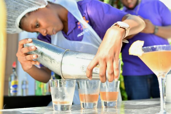 A student leader from A.Z Preston Hall, UWI (Mona) pours servings of her team’s cocktail creation during a team building exercise at Sandals South Coast.