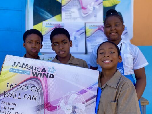  (From left)  Broughton Primary School students Amari Whyte, Rodger Williams Anise Anderson and Jordan Subaxon were elated to receive fans for their classrooms donated by the Sandals Foundation.