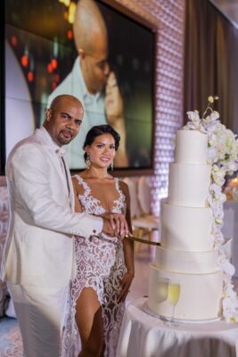 Mr. and Mrs. Adams get ready to cut into their five layered cake.