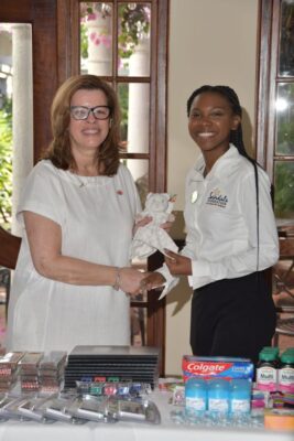 Air Canada, Senior Manager Regional Sales Global Sales Air Canada group, Edna Ray, handing over a donation of items for teen moms to Sandals Regional Public Relations Coordinator for Montego Bay Ashley Simms, who accepts on behalf of the Sandals Foundation.