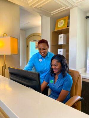 Tamika Robb-Scott assisting Spa Receptionist, Anecia Buchanan-Allen.