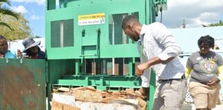 Business Development Manager from Jamaica Recycles, Richard Campbell enlightens the Sandals South Coast Earth team members on the importance and the function of the baler unit.