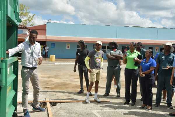 Business Development Manager from Jamaica Recycles, Richard Campbell enlightens the Sandals South Coast Earth team members on the importance and the function of the baler unit.