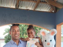 General Manager of Sandals Montego Bay Christopher Elliott happily poses for a picture with the Easter bunny and four-year-old Deneisha McFarlane of Whitehouse.